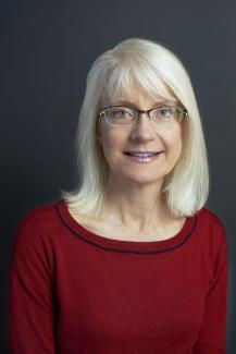 Headshot of Prof. Jennifer Brodbelt, guest speaker, woman with blonde hair, wearing glasses and a dark red top